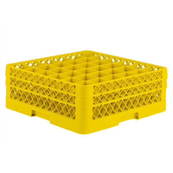 A yellow plastic Vollrath Traex glass rack with 36 compartments each with a hole for a small item.