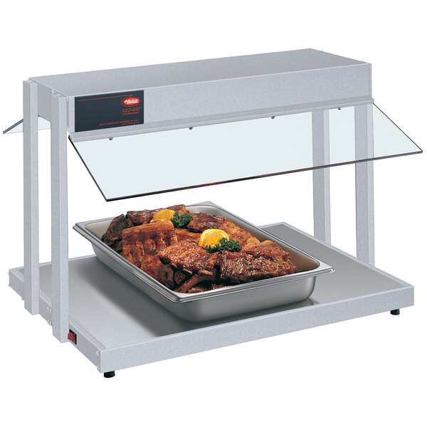A Hatco countertop buffet warmer with a tray of meat on it.