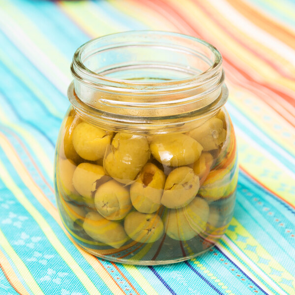 An American Metalcraft condiment mason jar filled with green olives.