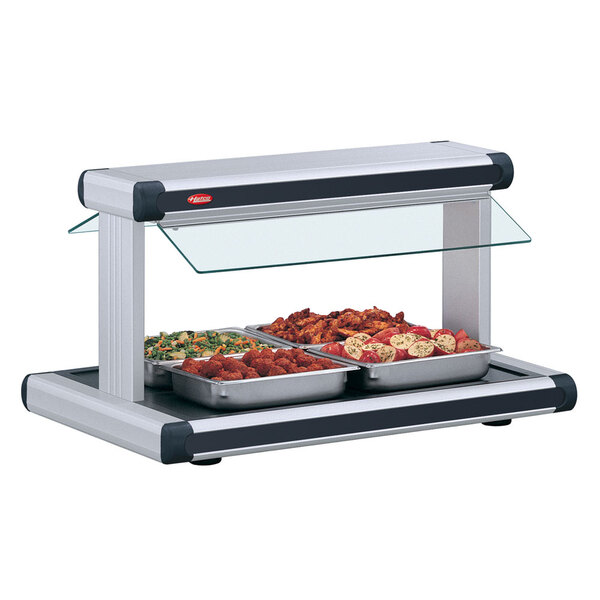 A Hatco buffet food warmer with black insets holding food on a buffet tray.