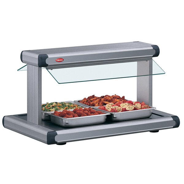A Hatco countertop buffet warmer with gray granite insets holding food.