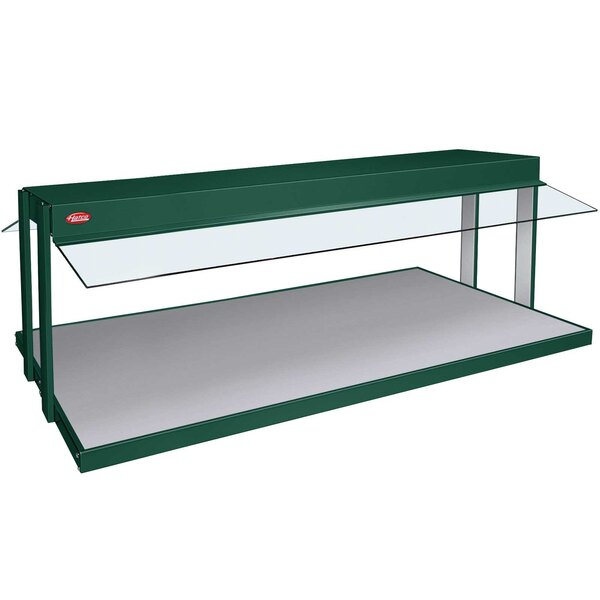 A green and white Hatco countertop buffet warmer with glass shelves.