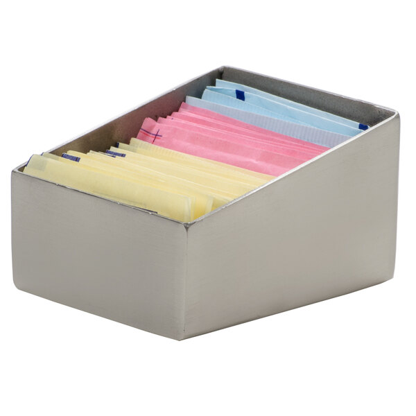 An American Metalcraft rectangular stainless steel sugar caddy with different colored packets inside.