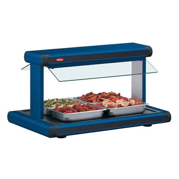 A navy blue Hatco buffet warmer with black insets holding trays of food.