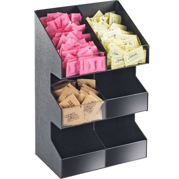 A black plastic Cal-Mil double wide condiment display shelf with clear bins holding several packets.