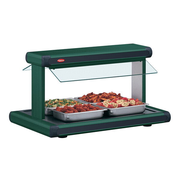 A Hatco buffet food warmer with green and black inserts holding food on a countertop.
