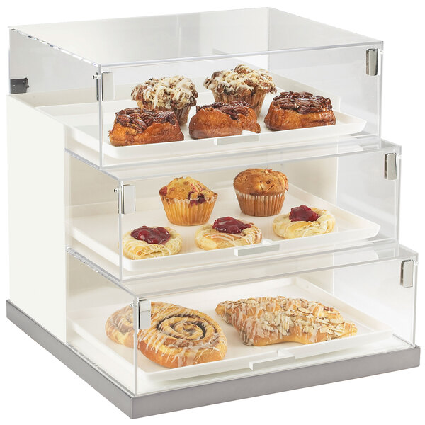 A Cal-Mil stainless steel bakery display case with pastries inside.