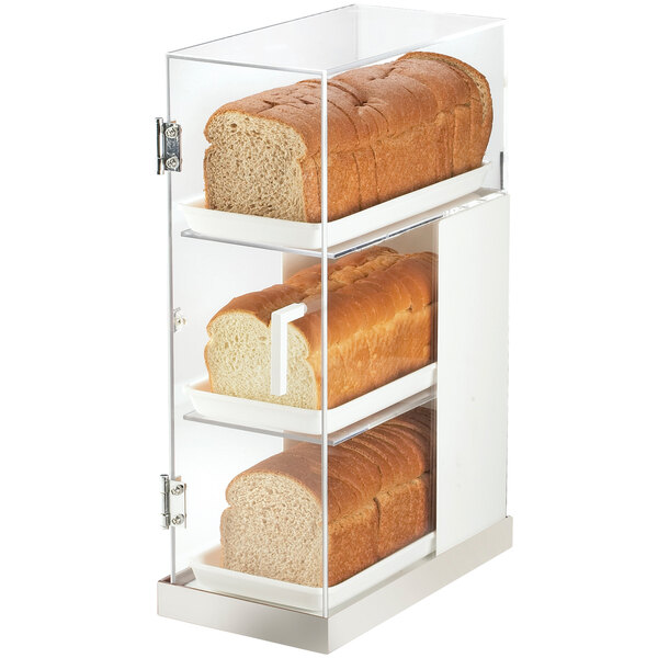 A Cal-Mil stainless steel bread case with three shelves holding loaves of bread.
