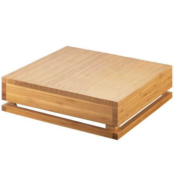 A Cal-Mil bamboo square crate riser on a wooden square table.
