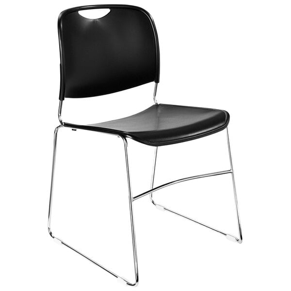 A National Public Seating black plastic stacking chair with chrome legs.