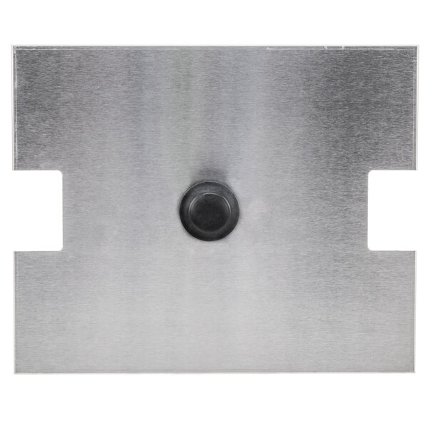 A metal plate with a black circle in the center.