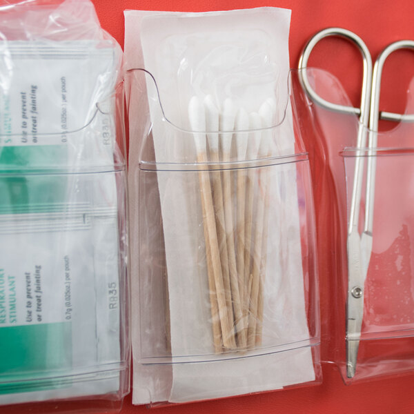 A pack of Medique cotton tip applicators in clear plastic containers with scissors and tweezers.