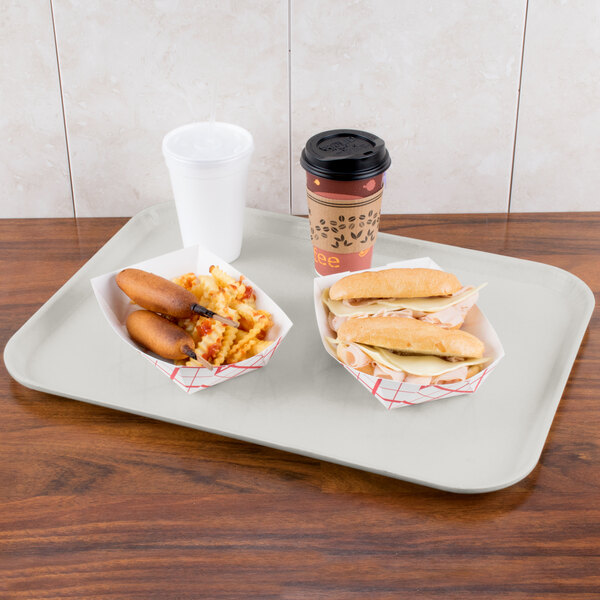 A Carlisle Glasteel tray with a hot dog and a drink on it.