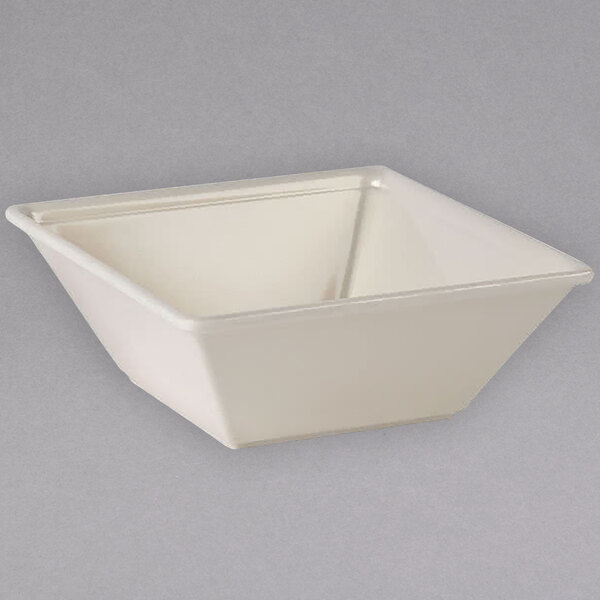 A white square Thunder Group melamine bowl with a triangle shaped bottom.
