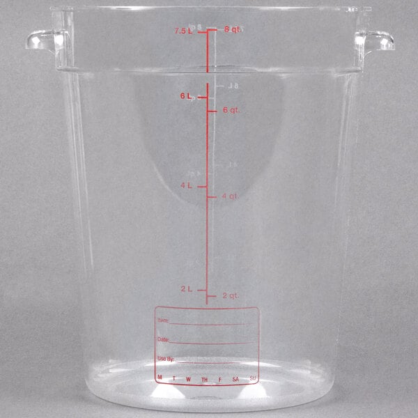 A Carlisle clear plastic food storage container with a measuring line.