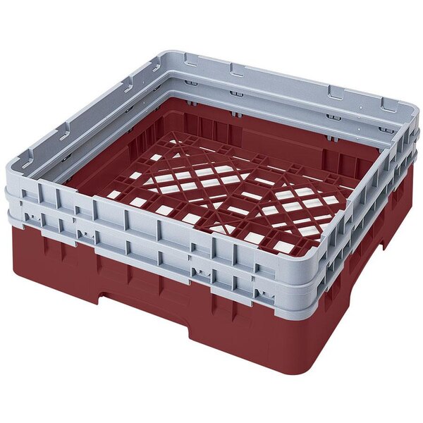 A red plastic Cambro dish rack with closed sides and 2 extenders.
