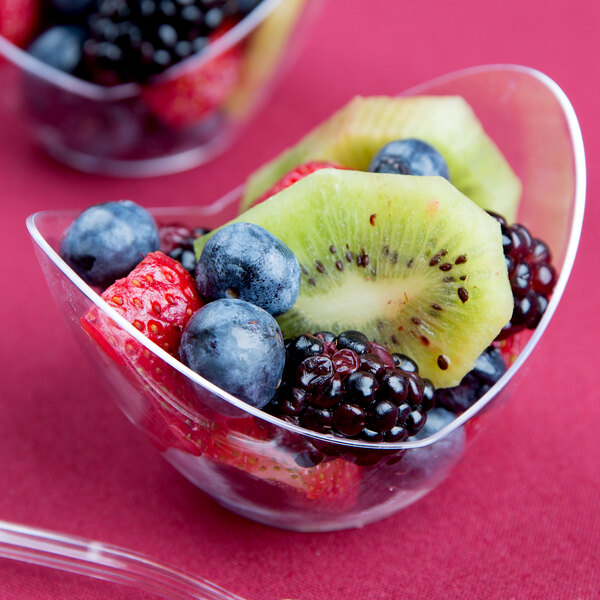 A clear Fineline Tiny Tureens bowl filled with fruit.