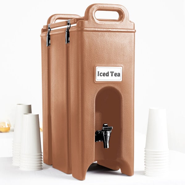 A brown Cambro insulated beverage dispenser with a black dispenser and cups.