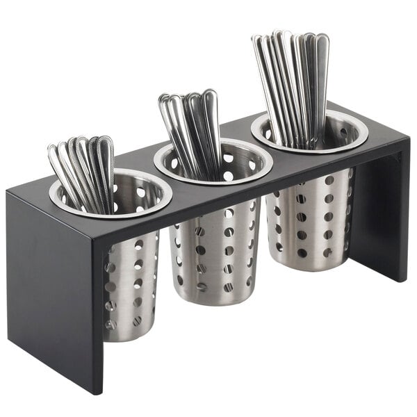 A black metal container with three metal tubes holding silverware.