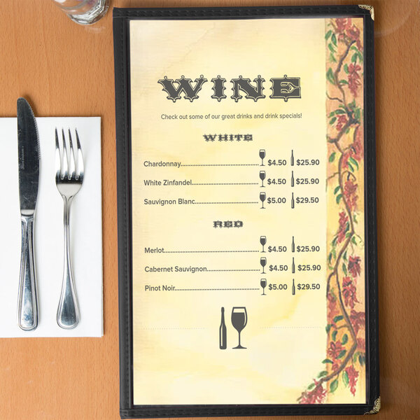 Menu paper with a Mediterranean villa design on a table with wine glasses and wine bottles.