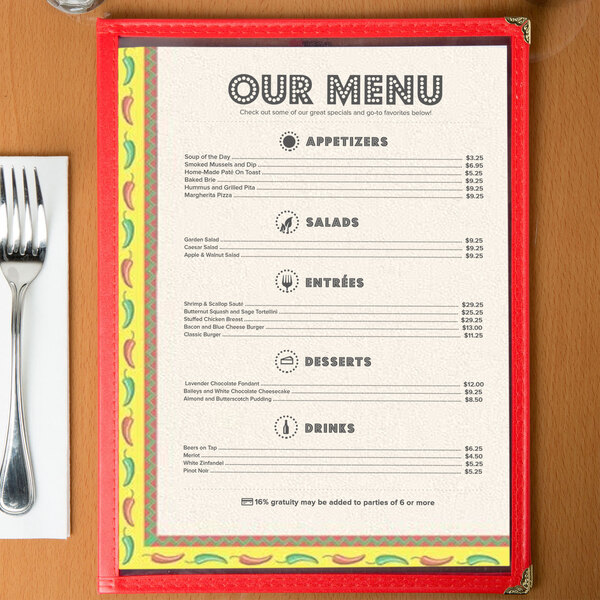 Menu paper with a Southwest themed Mariachi design on a table with a fork and knife.