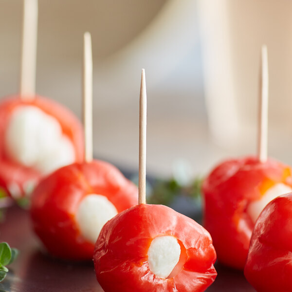 A plate of red peppers with Royal Paper wooden toothpicks.