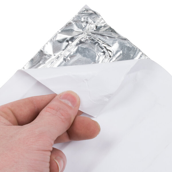A person holding a heater blanket foil piece.