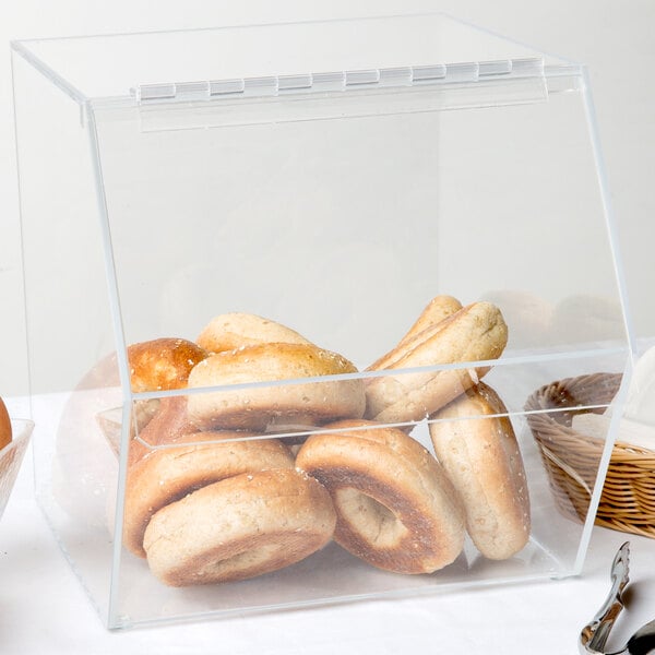 A clear Cal-Mil stackable food bin with bagels inside.