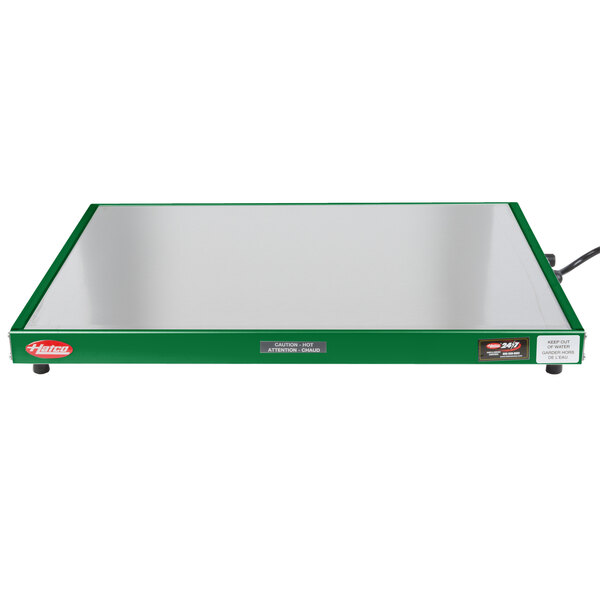 A green rectangular Hatco heated shelf warmer with a wire.