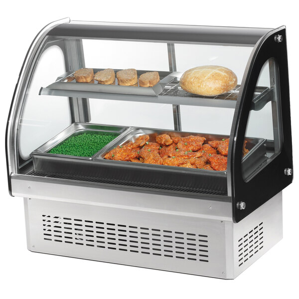 A Vollrath curved glass heated countertop food display case with food inside.