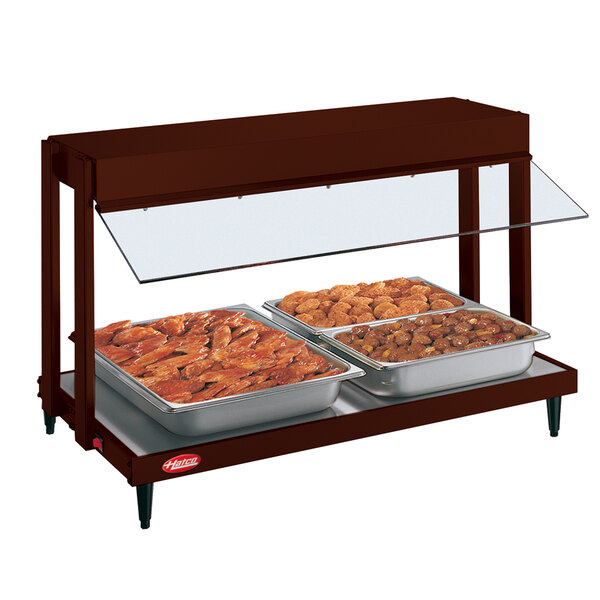 A Hatco countertop food warmer with two trays of meat in a row.