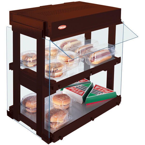 A Hatco countertop food display warmer with food in a plastic container.