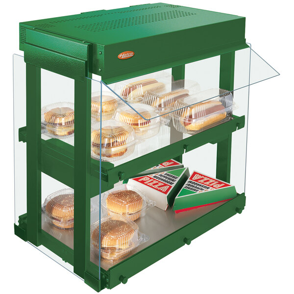 A Hatco Hunter green countertop warmer with food on shelves.