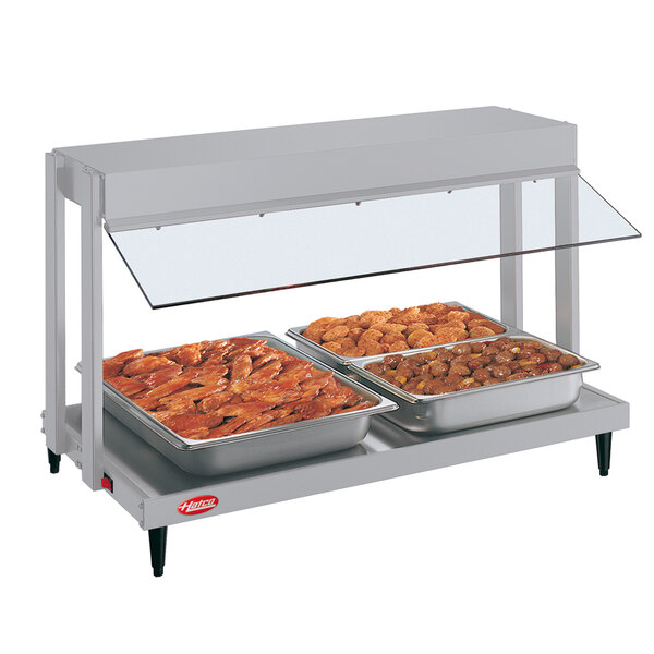 A white Hatco countertop food warmer with two trays of meat.