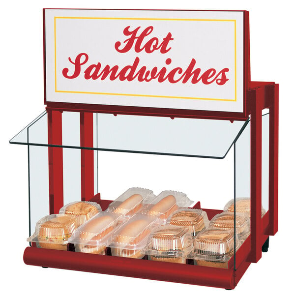 A Hatco countertop warmer with a hot dog and bun in a plastic container.