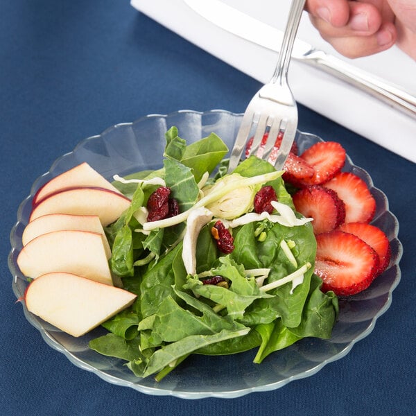 A Libbey glass salad plate with a slice of apple on it.
