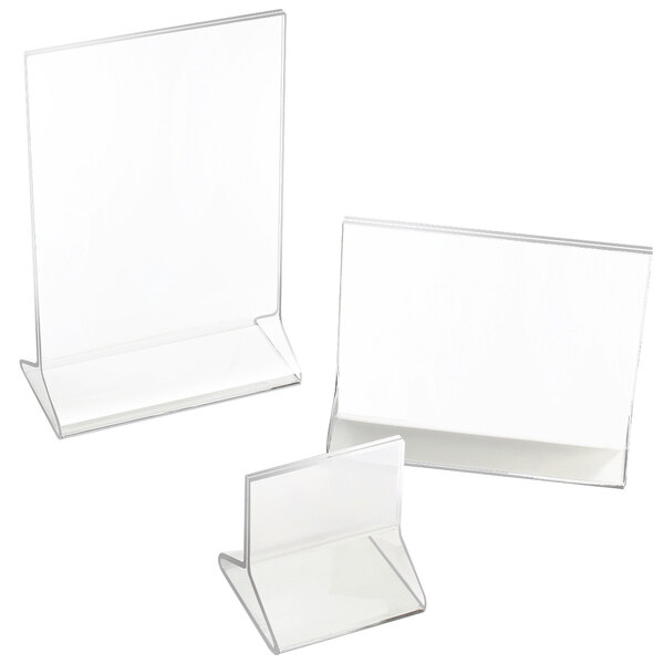 A group of clear Cal-Mil acrylic display stands with white borders.