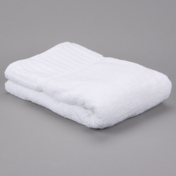 A folded white Oxford Signature bath towel