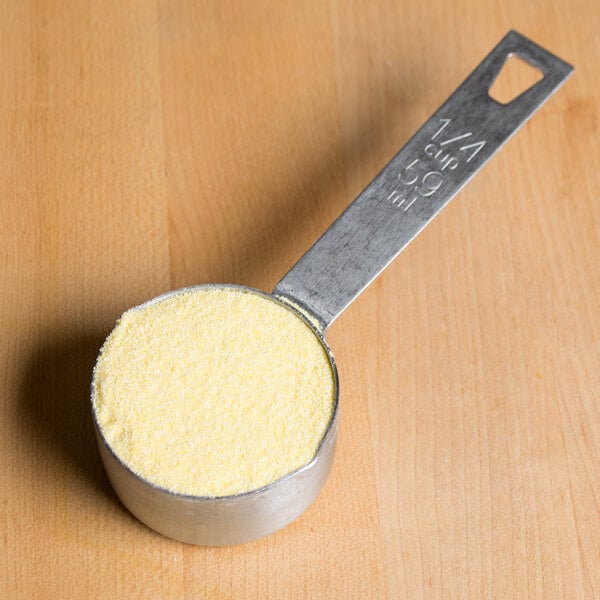 A measuring spoon with Agricor Coarse Yellow Cornmeal.