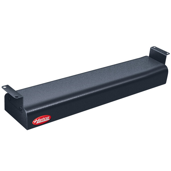 A black metal rectangular object with holes and a red toggle switch.