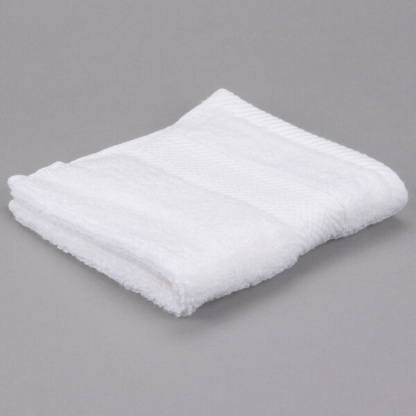 A white Oxford Miasma wash cloth on a gray surface.