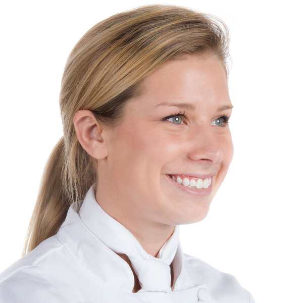 A woman wearing a white Chef Revival neckerchief and smiling.