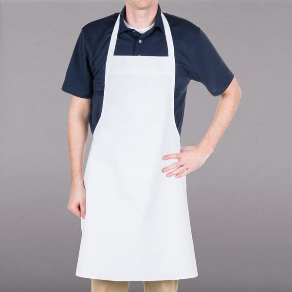 A man wearing a white Chef Revival bib apron.