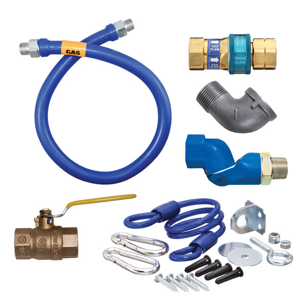 A blue Dormont gas connector kit with fittings, a flexible hose, and a yellow label.