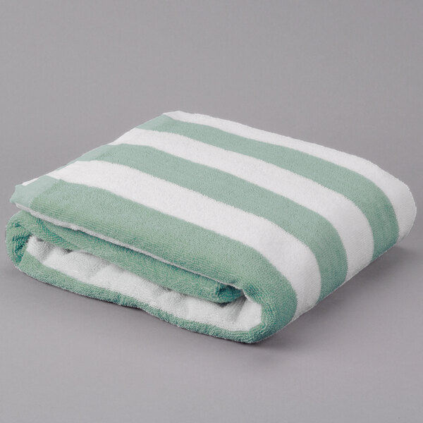 A folded Oxford pool towel with green and white stripes.