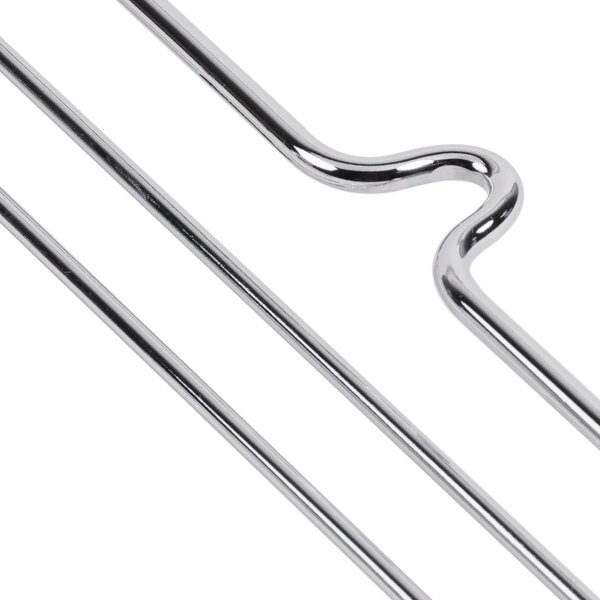 A pair of silver plated metal hooks with several metal rods.