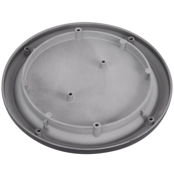 A grey circular warming plate with holes.