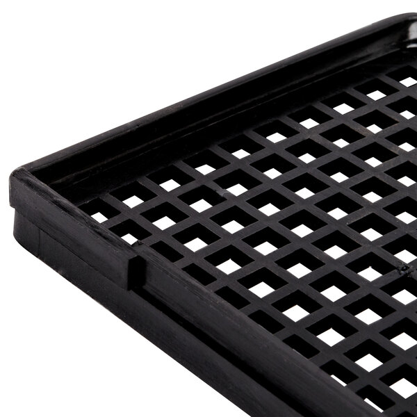 A black plastic reservoir screen with a grid pattern of holes.