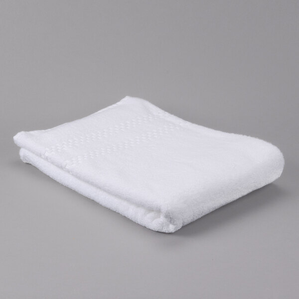 A folded white Oxford Viceroy pool towel on a gray background.
