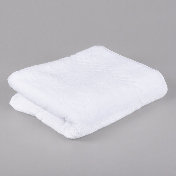 A white folded Oxford Viceroy towel on a gray surface.